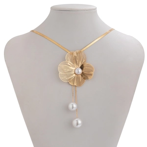Elegant gold flower necklace with white pearls and long tassels on a white mannequin
