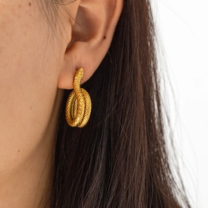 Close-up of 18K gold snake-shaped stainless steel earrings showing worn effect