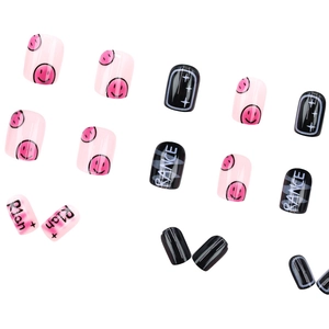 Colorful smiley face press-on nails with pink and black patterns on white background