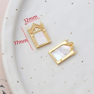 Macro detail of 14k gold-filled gothic window shell pendant showing 12x17mm dimensions