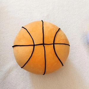 Detailed view of plush basketball pillow with soft texture and black stitching accents