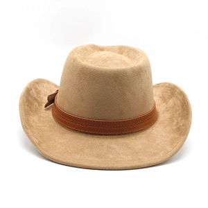 Close-up of wide-brimmed suede cowboy hat with brown leather band and stitch details