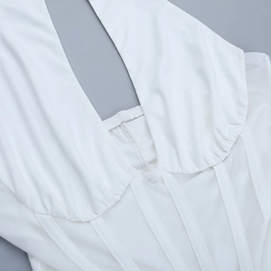 Close-up of white halter neck dress featuring mesh stitching and corset boning detail