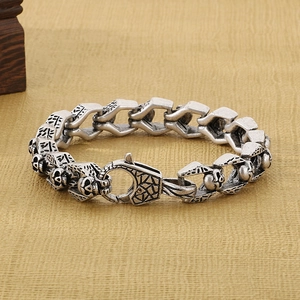 Detail of vintage silver skull bracelet showing punk links and antique metal texture