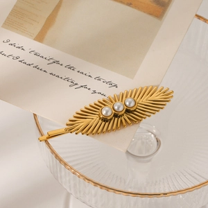 Golden sunburst stainless steel hair clip with pearls on elegant display card