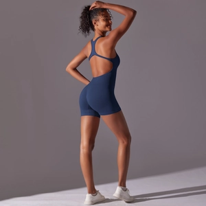 Detail of a navy blue backless yoga romper with high-stretch seamless athletic fabric