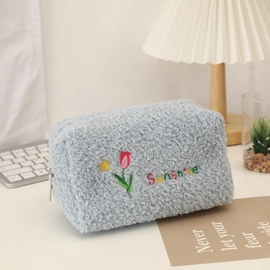 Detail of blue plush tulip bag with sunshine embroidery and soft sherpa texture