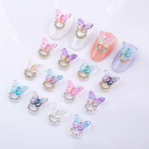 Macro shot of 15 colorful 3D gradient resin butterfly nail charms with diamond bases