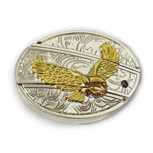 Detail showing an eagle relief design on a gold and silver oval belt buckle