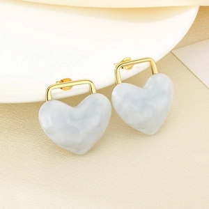 Close-up of 18K gold-plated heart earrings with grey marble texture resin inlay