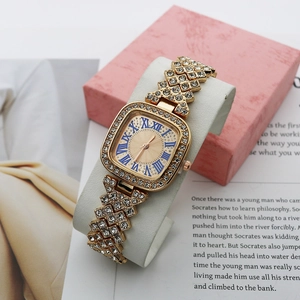 Luxury square gold women's watch with crystals, beige dial, and blue Roman numerals