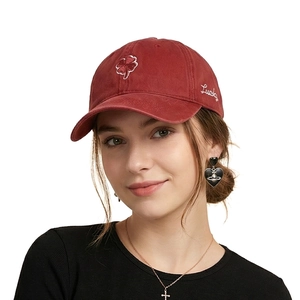 Detail showing clover embroidery and Lucky script on red cotton baseball cap