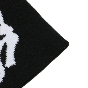 Close-up of the high-quality black and white knitted bone pattern on the punk beanie