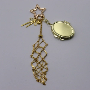 Detail of golden metal bow pendant featuring a star clasp and mesh tassel accessory