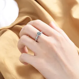 Classic silver-colored twisted band ring with a six-prong crown setting on model's finger