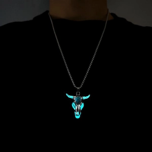 Luminous bull skull necklace for men with turquoise detail glowing in dark environment