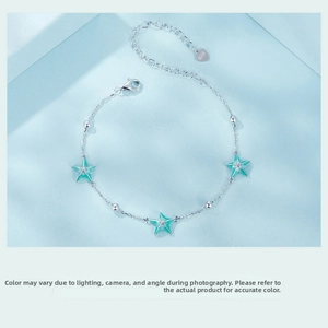 Close-up of S925 sterling silver bracelet with three green starfish enamel pendants