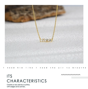 Macro detail of gold necklace pendant featuring sparkling marquise-cut zircon stones