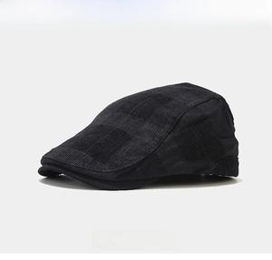 Detail view of high-quality black knitted fabric texture on stylish retro beret cap