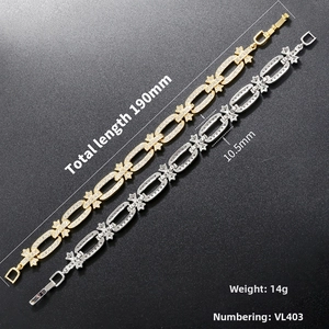 Detail view of gold and silver geometric cross chain link bracelets with crystal inlay