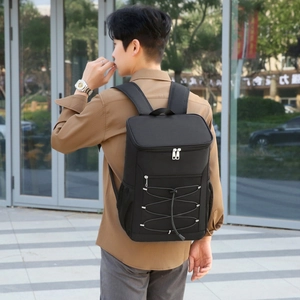 Black insulated oxford cloth lunch backpack for picnics shown on a model outdoors