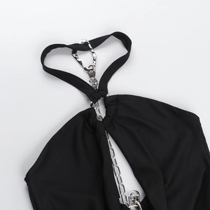 Detail of silver metal chain and hardware on black halter neck mini dress