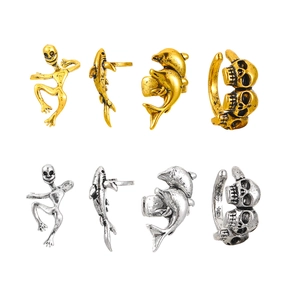 Gothic skull and shark ring set in gold and silver finish on white background