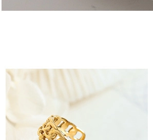 Macro detail of golden chain link hollow woven ring with exquisite metallic luster