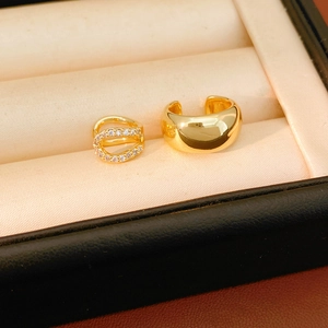 Detailed close-up of 18k gold-plated ear cuffs with sleek finish and zircon pavé setting