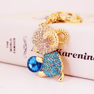 Cute golden sheep keychain with blue crystals and round blue gemstone accessory