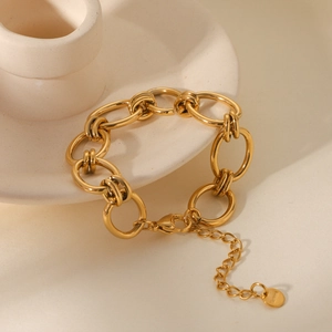 Detailed view of golden link bracelet with chunky oval rings and lobster clasp closure