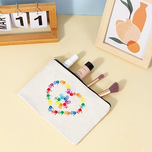 Close-up of white canvas cosmetic bag with heart print in a lifestyle desk setting