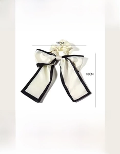 Detailed size specifications for the cream bow hair tie with black contrast edging
