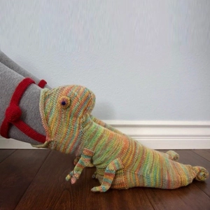 Detail of colorful knitted chameleon socks with creative 3D crochet textures and tail