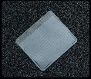 Macro shot of translucent gray self-adhesive jewelry pouch with fine mesh texture detail