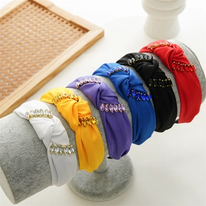 Fashion wide knotted headbands with rhinestones in six colors on a velvet display