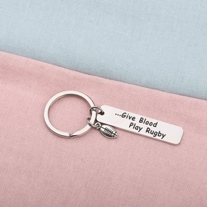 Stainless steel rugby keychain featuring 'Give Blood Play Rugby' engraving on silver bar