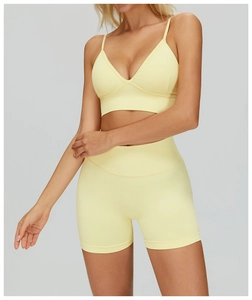 Detail of light yellow ribbed seamless yoga bra and high-waist sports shorts set