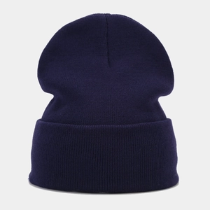 Close-up of high-quality navy blue ribbed knit texture on a warm winter cuffed beanie