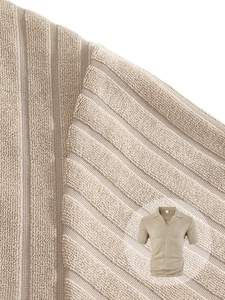 Macro detail of beige knit polo fabric with textured waffle weave and button collar