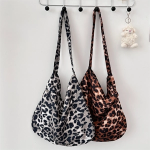 Detailed close-up of high-capacity leopard print tote bags in grey and brown canvas