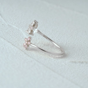 Detail of S925 sterling silver open ring with pink flower and sparkling zircon stone