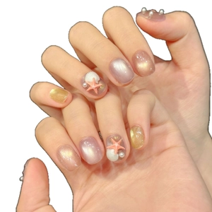 Summer ocean themed press-on nails with pink cat eye base, 3D starfish and pearl charms