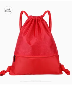 Detail of red nylon drawstring bag featuring honeycomb texture and zipper pocket