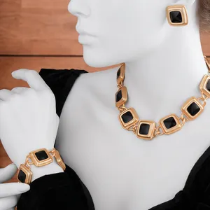 Vintage style jewelry set with gold square earrings and necklace on a model