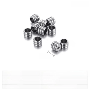 Macro detail of 5mm stainless steel spacer beads with triple groove design and steel finish