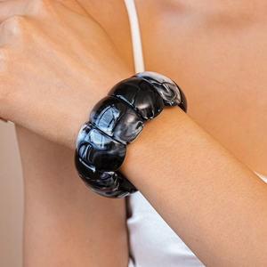 Detailed close-up of acrylic resin bracelet with black and white marble textures