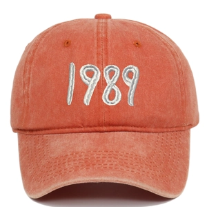 Close-up of vintage washed cotton baseball cap with 1989 embroidery in brick red