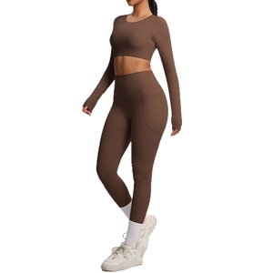 Two-piece chocolate brown yoga set featuring long sleeve crop top and leggings with pockets