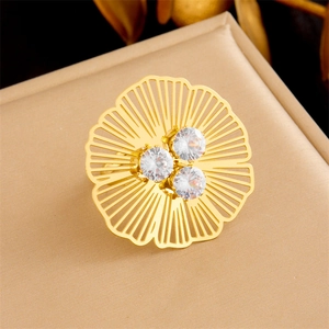 Golden stainless steel ring featuring hollow flower design with three inset clear crystals